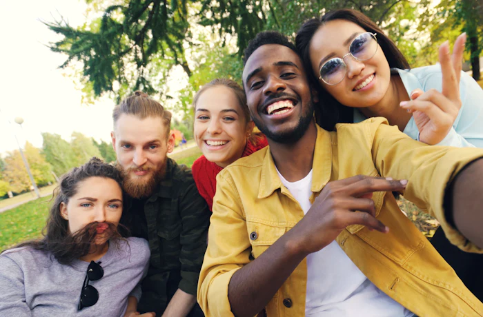 Diverse group of friends smiling together outdoors