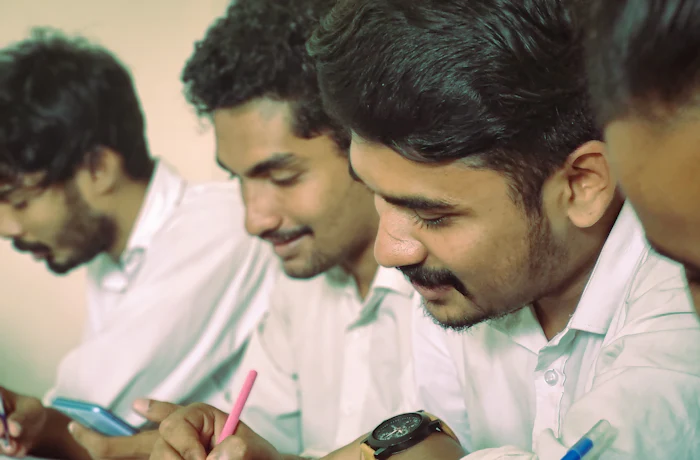 Group of engineering students in Kerala, India reviewing their coursework together