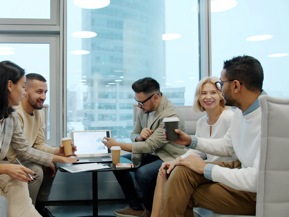 Diverse team of professionals reviewing plans together in a modern office